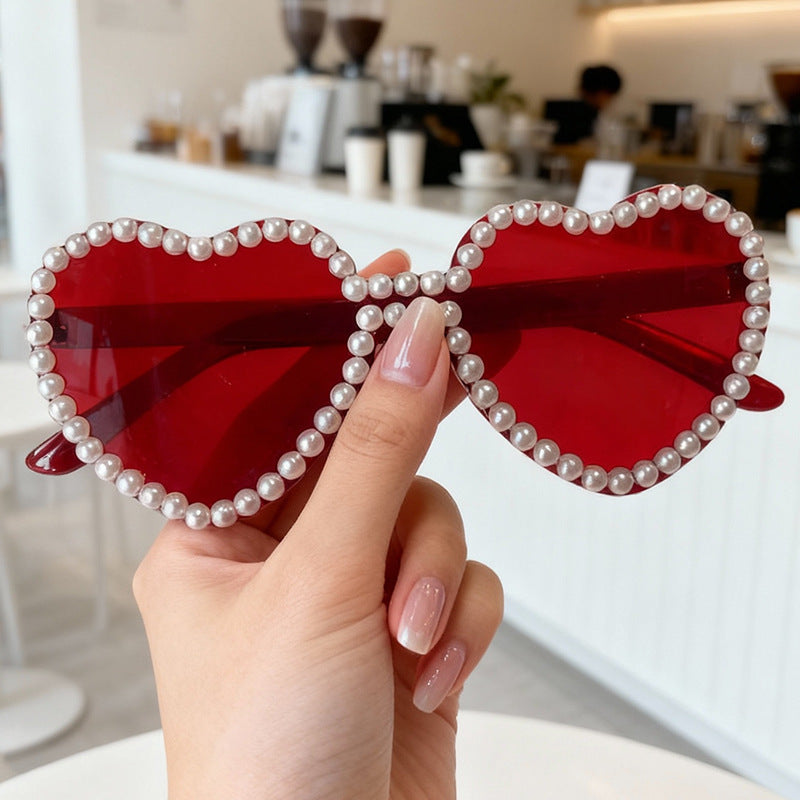 Close-up of Women's Heart Pearl Accent Sunglasses, front view, showcasing design.