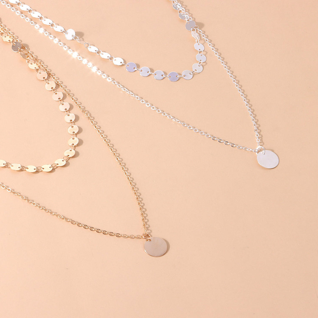 Elegant layered disc chain necklace for women, showcasing a mix of gold tone & silver tone finishes. Fashion jewelry.