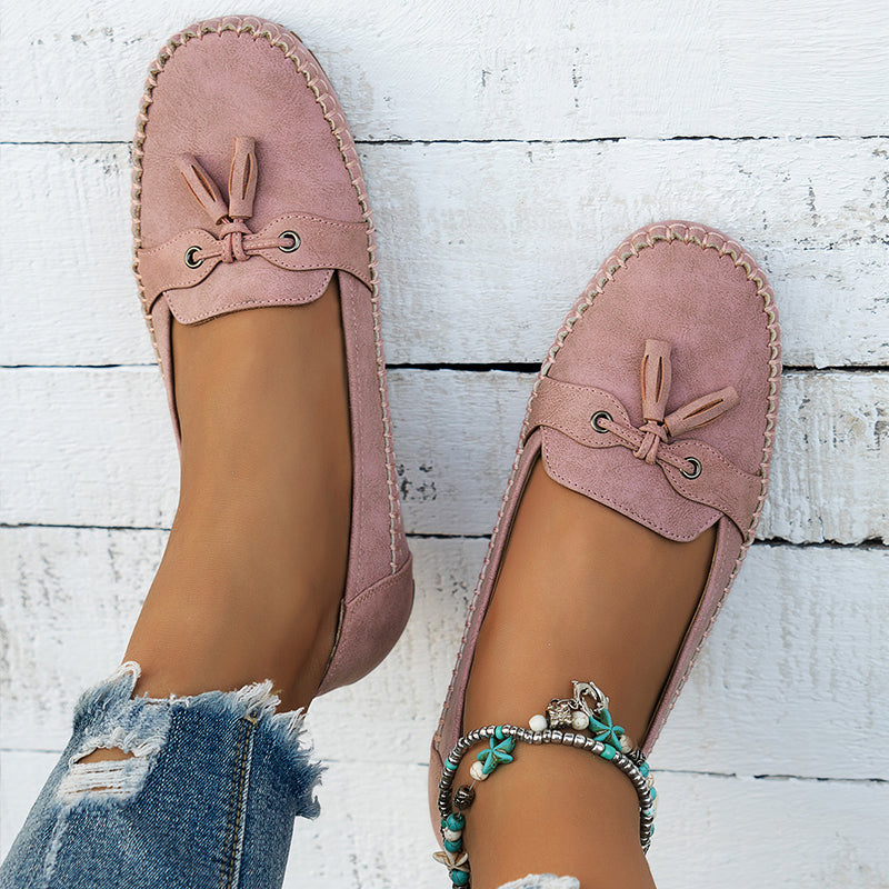 Side view of women's comfort tassel loafers, highlighting orthopedic arch support.