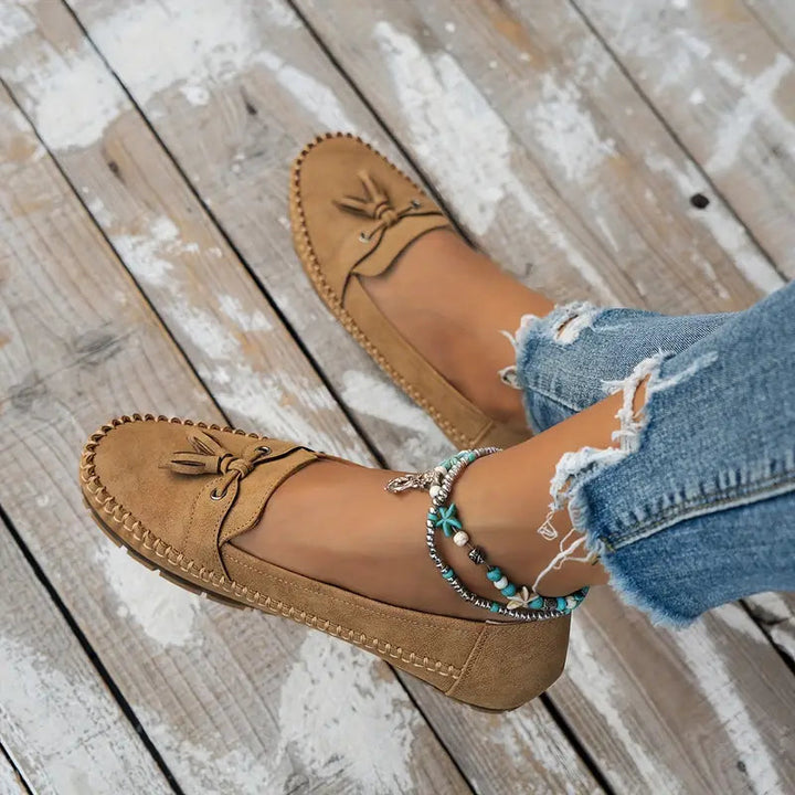 Women's elegant slip-on shoes: black orthopedic tassel loafers for foot health.