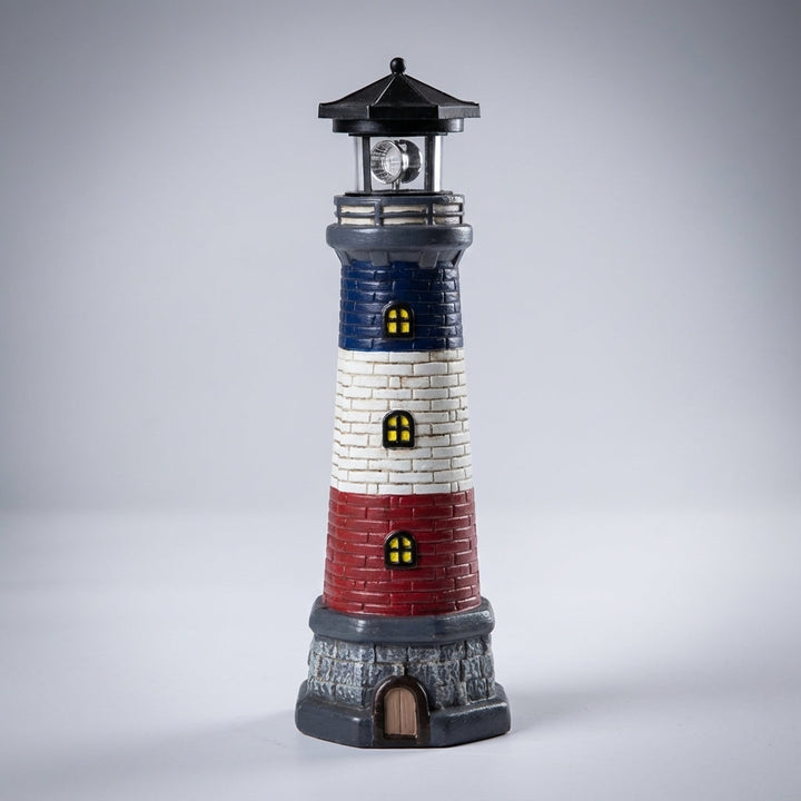 Automatic coastal lighthouse solar garden light. Weather-resistant LED beacon for charming outdoor decor.