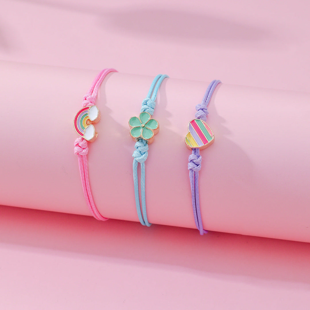 Adjustable friendship bracelet set of 4, featuring cute heart, rainbow, and flower charms for women.