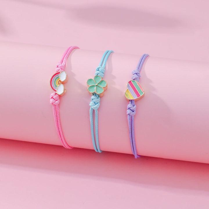 Adjustable friendship bracelet set of 4, featuring cute heart, rainbow, and flower charms for women.