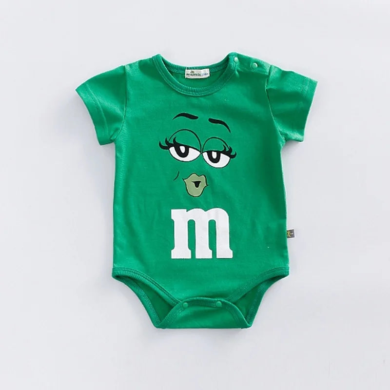 Colorful baby romper with M&M faces for infants & toddlers. Short sleeve, snap closure, comfy casual summer wear.