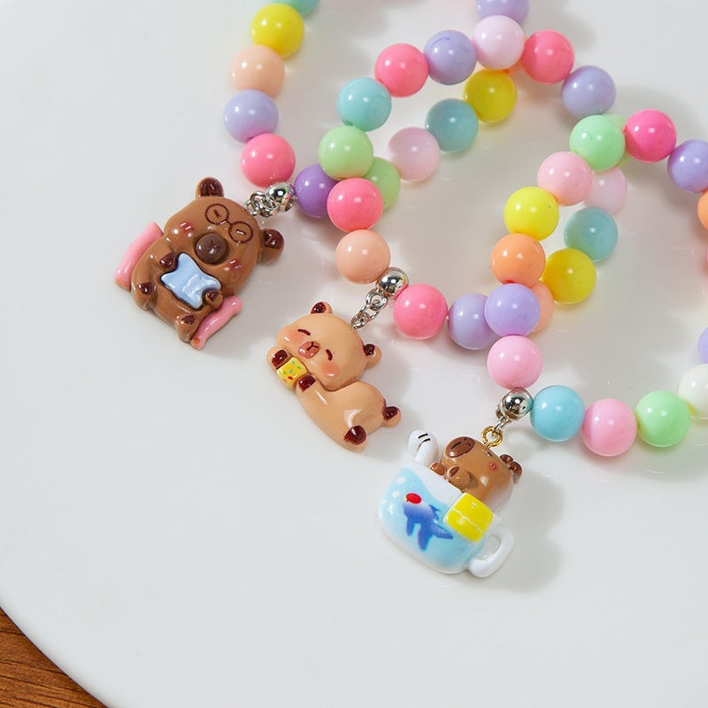 Colorful children's charm bracelet with playful plastic beads, adjustable for kids' wrists.
