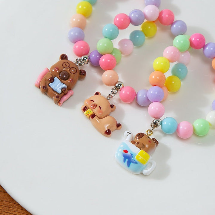 Colorful children's charm bracelet with playful plastic beads, adjustable for kids' wrists.