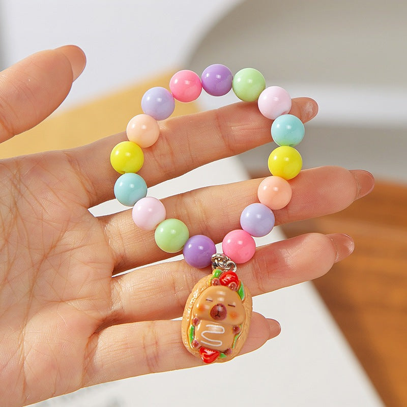 Fun children's accessory: a colorful, adjustable charm bracelet with plastic beads & animal charms.