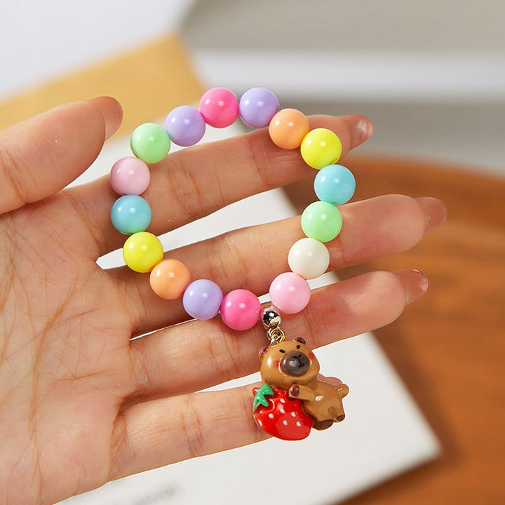 Gift for kids: an adjustable, colorful charm bracelet with playful plastic beads & charms.