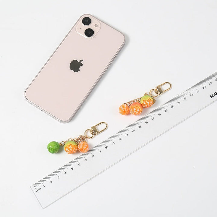 Eye-catching fruit-themed keychain for bags, a vibrant and durable key holder and purse accessory.