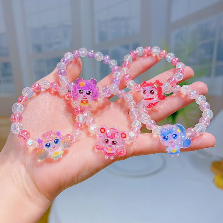 Close-up of a vibrant girls' charm bracelet with various cartoon character charms, perfect playful accessory.