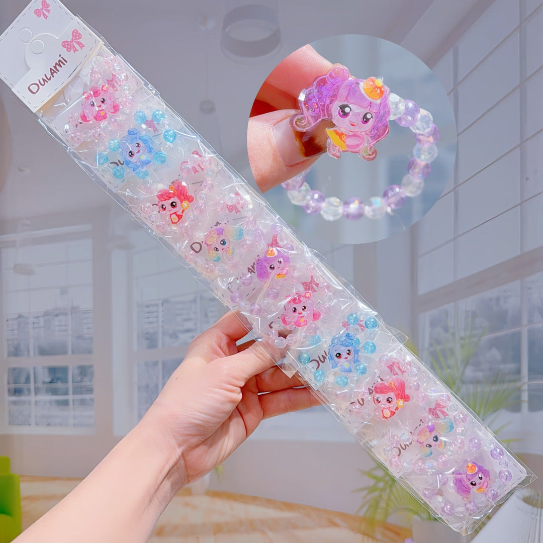 Hand modeling a girls' adjustable charm bracelet with colorful cartoon figures, a trendy playful accessory.