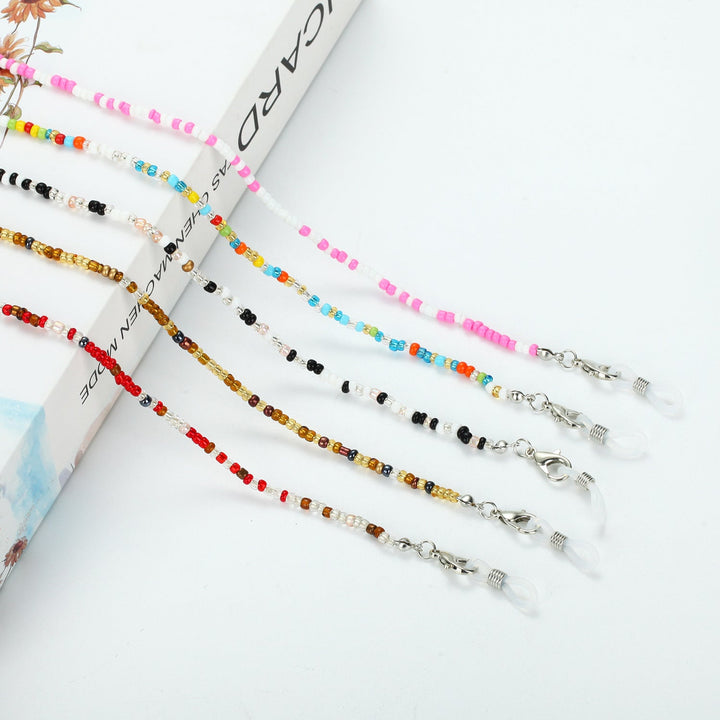 Vibrant glass beads form a colorful unisex necklace, secured by a sleek carabiner clasp. Trendy jewelry.