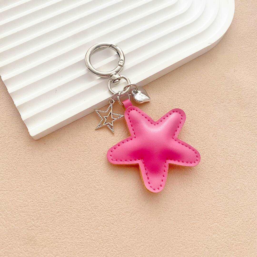 Starfish leather key holder with intricate details, a stylish and unique bag accessory gift.