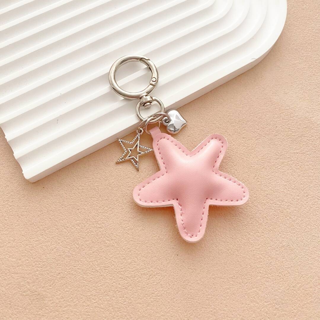 Unique starfish leather keychain with vibrant colors, ideal for keys or as a stylish bag accessory.