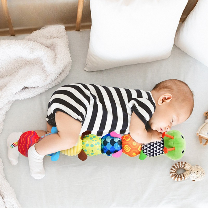 Colorful musical caterpillar plush toy for baby sensory play & motor skill development.