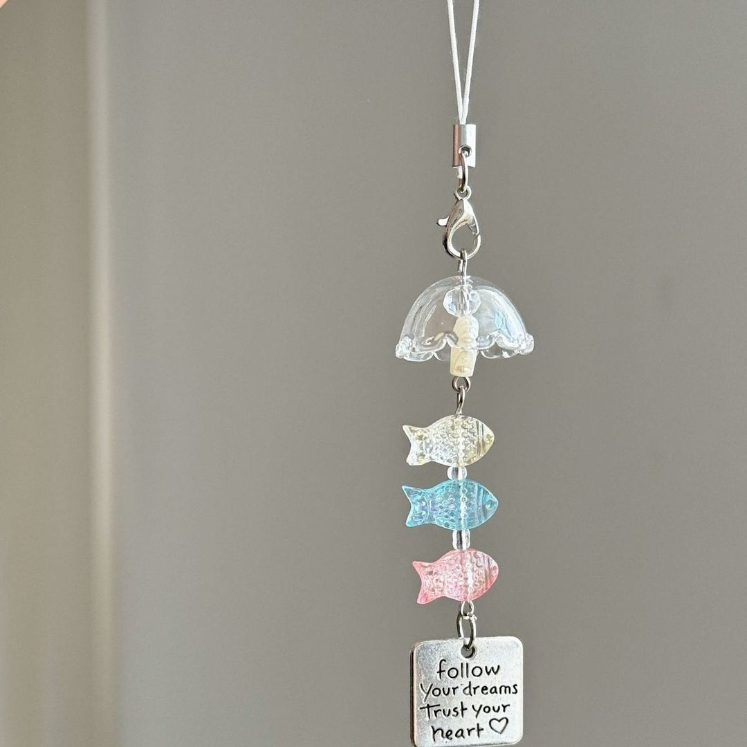 Playful plastic ocean charm keychain featuring various marine creatures and shells, a vibrant nautical accessory.