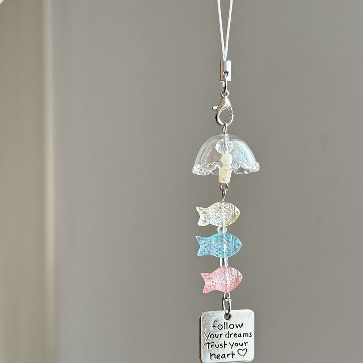 Playful plastic ocean charm keychain featuring various marine creatures and shells, a vibrant nautical accessory.
