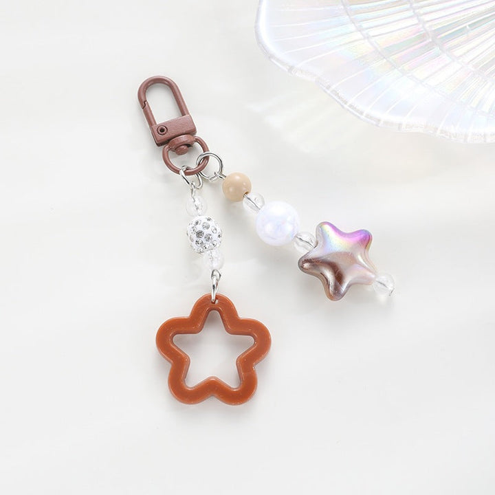 Intricate floral pattern on a star keychain, a unique and stylish key accessory.