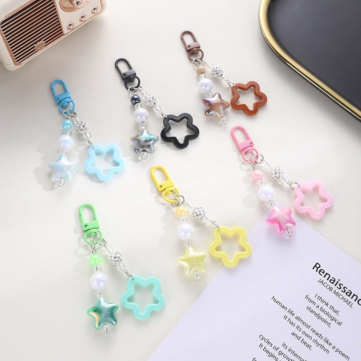 Stylish star-shaped keychain with intricate floral design, a perfect accessory.