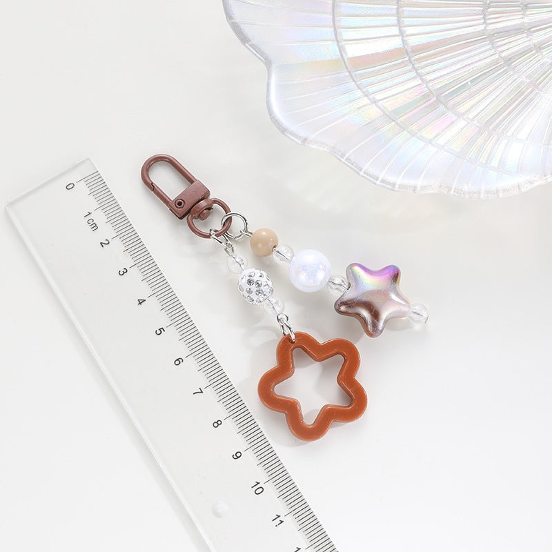 Durable plastic floral star keychain, a colorful & lightweight key accessory.