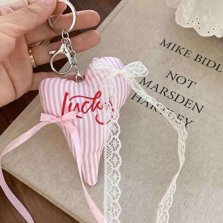 Unique striped heart accessory, a colorful fabric keychain for keys or bags.