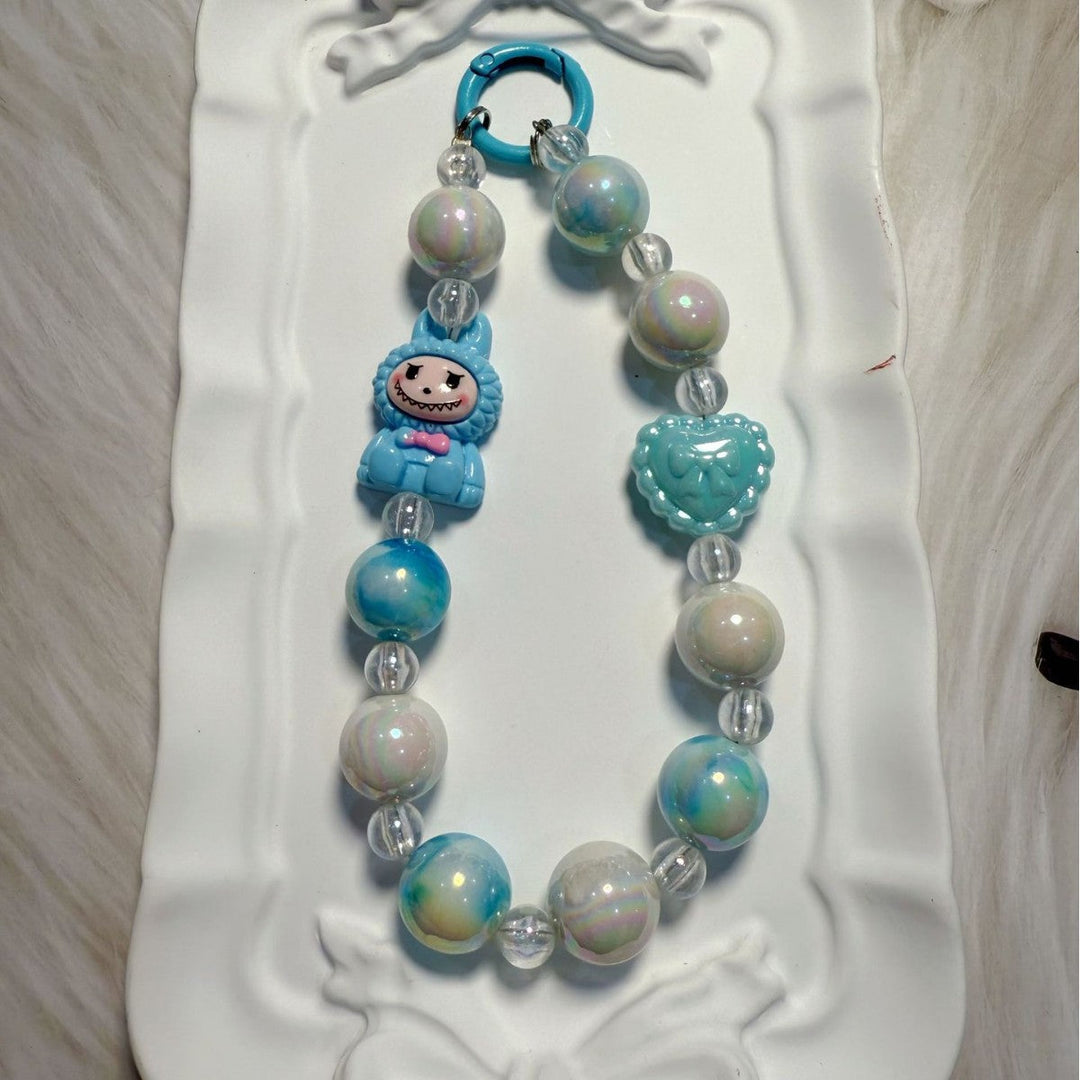 Artisan-style whimsical beaded charm, a vibrant handmade-look accessory for bags & keys.