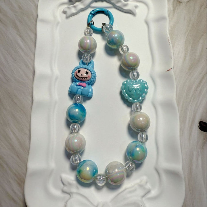 Artisan-style whimsical beaded charm, a vibrant handmade-look accessory for bags & keys.