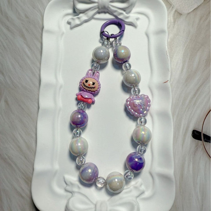 Handmade-style whimsical beaded accessory, perfect as a key holder or bag decoration.