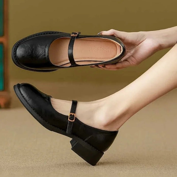 Women's comfortable Mary Jane flats featuring a low block heel & secure ankle strap, perfect for all-day wear.