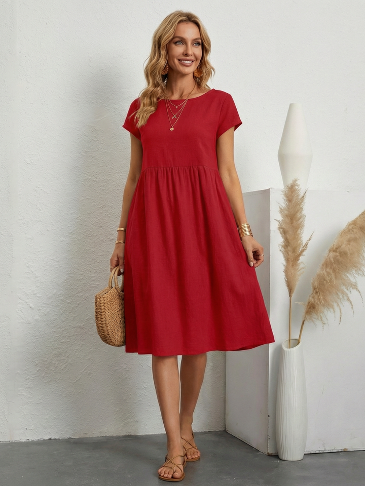Solid color women's short sleeve midi dress with pockets, offering comfortable casual everyday style.