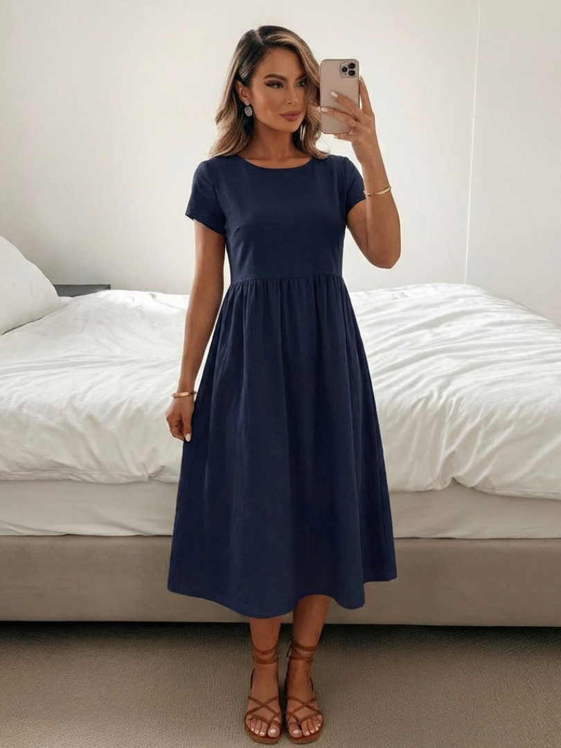 Relaxed fit women's midi dress with short sleeves & practical pockets, ideal for versatile casual styling.
