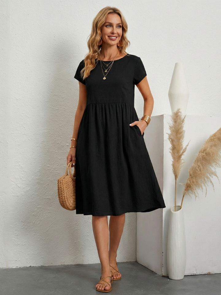 Soft & comfortable women's short sleeve knee-length dress with functional pockets for casual outfits.