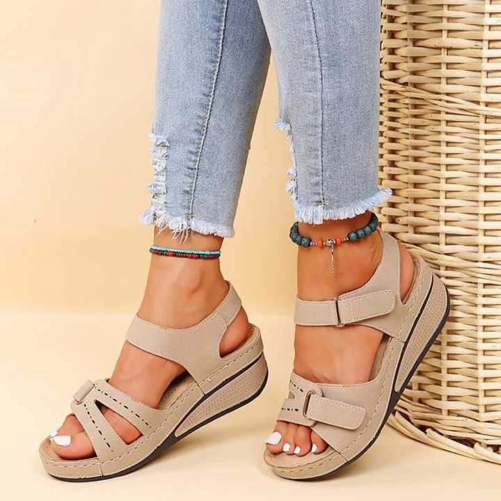 Stylish women's wedge heel sandals featuring an adjustable strap, ideal for comfortable all-day summer & spring wear.