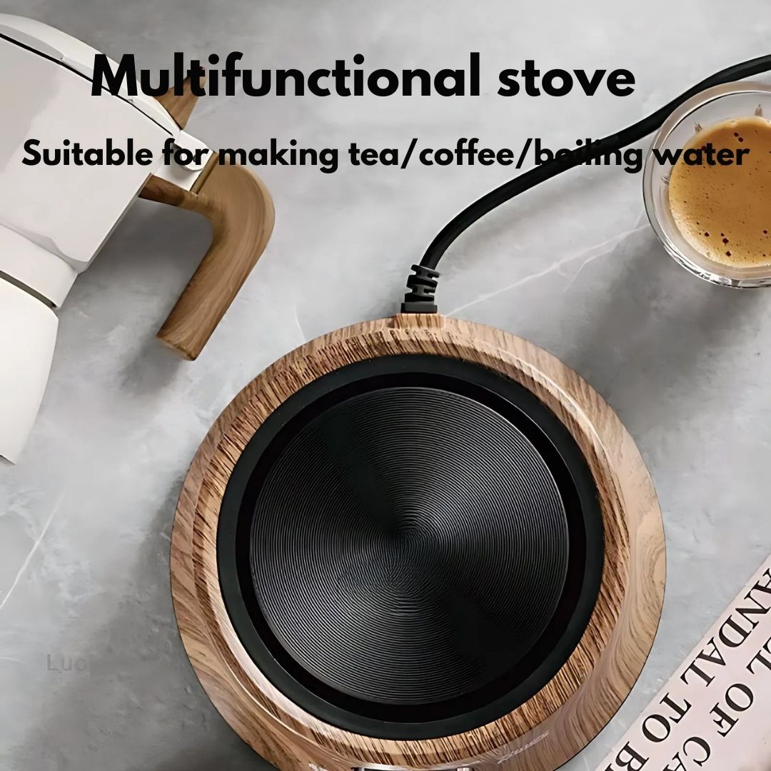 Compact electric hot plate heating a small pot on a kitchen counter. Adjustable temp control.