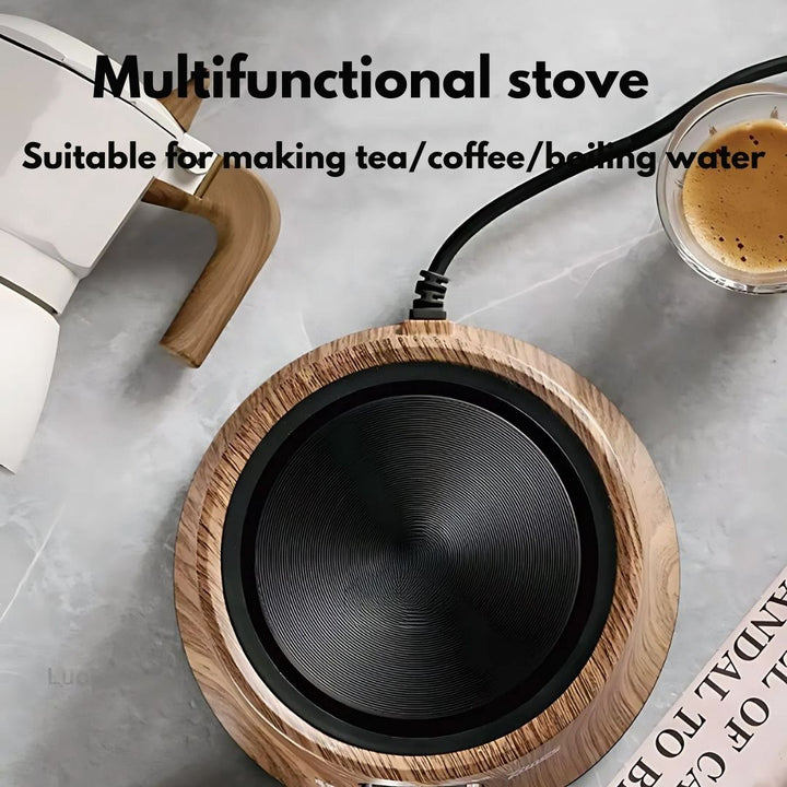 Compact electric hot plate heating a small pot on a kitchen counter. Adjustable temp control.