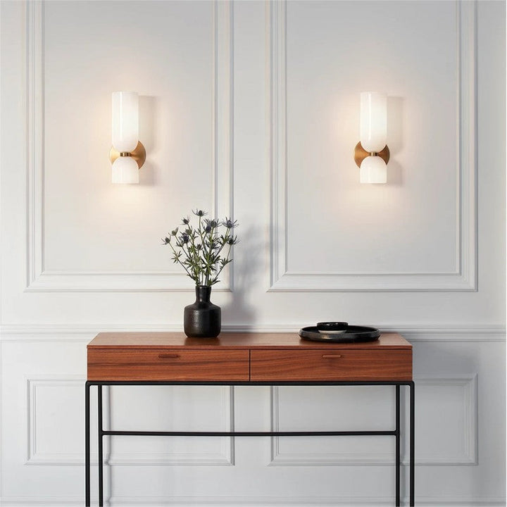 Stylish contemporary glass twin wall sconce, providing ambient light for upscale interior design.
