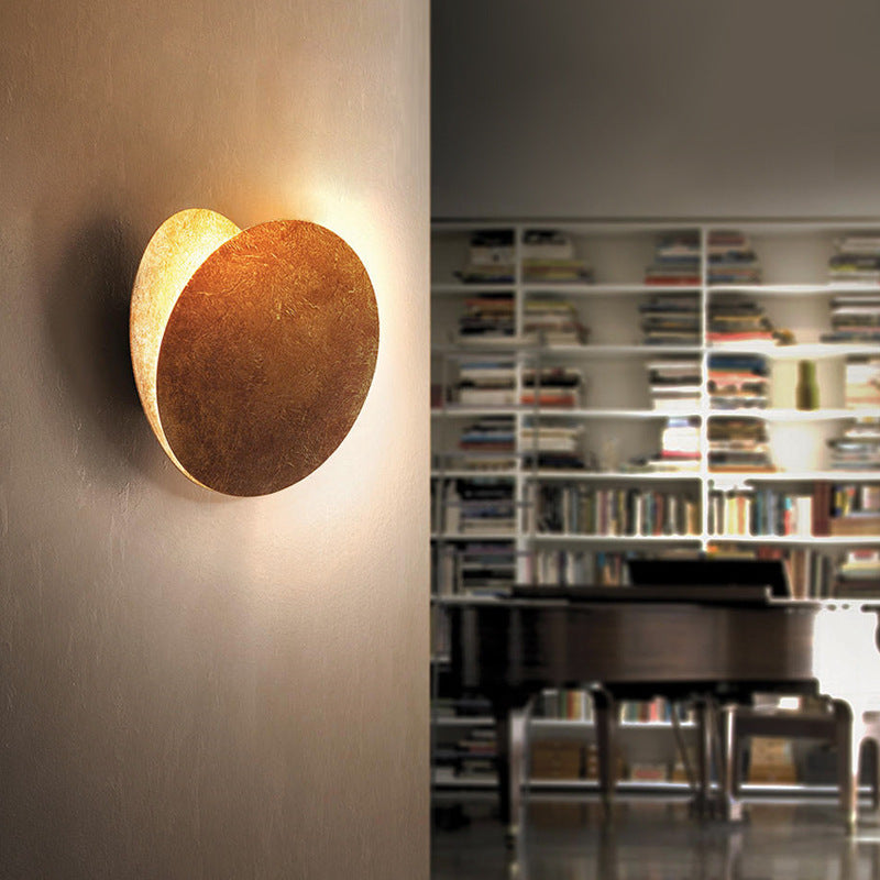 Modern Scandinavian round metal wall lamp, a decorative fixture with warm white ambient light.