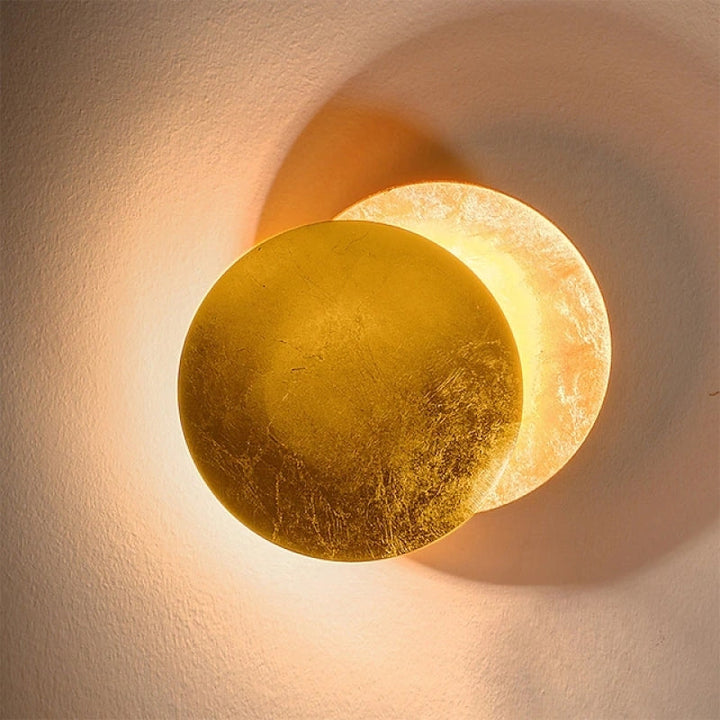 Elegant gold finish round indoor wall lamp, a contemporary decorative fixture for modern interiors.