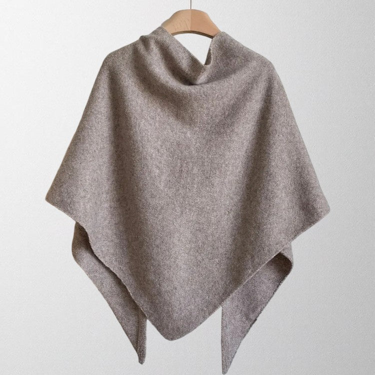 Woman wearing a flowing soft autumn scarf, draped elegantly as a stylish, cozy wrap.