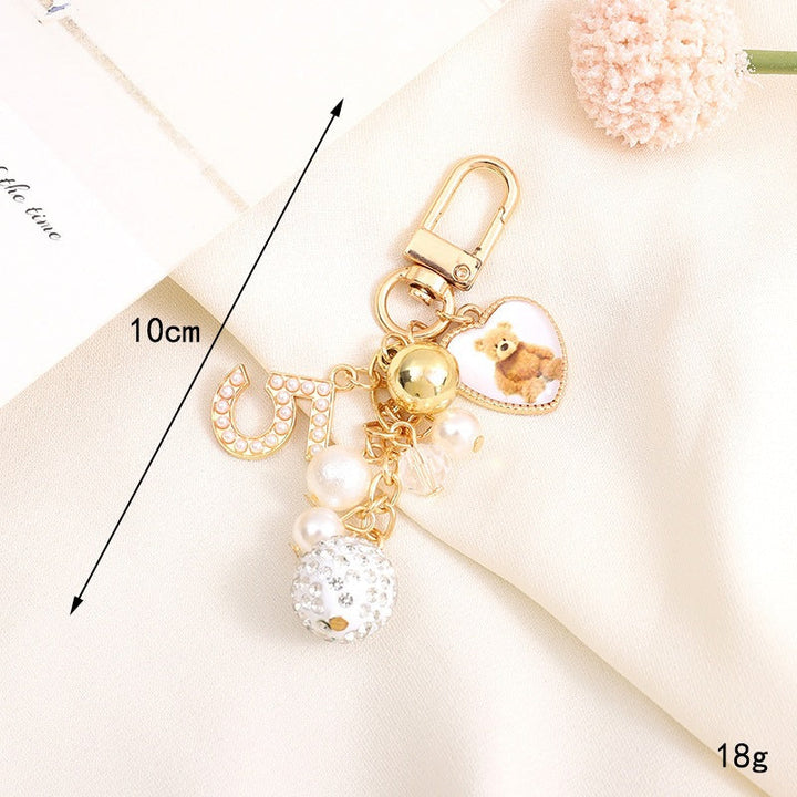 Stylish bear charm keychain for bags, featuring a heart and a mini bell, a great gift.