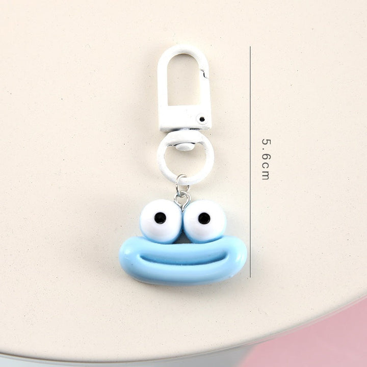 Colorful cartoon face bag charm & keychain, featuring a unique, playful design.