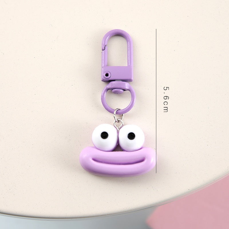 Unisex cartoon face keychain with a yellow smiling expression, ideal for backpacks & keys.