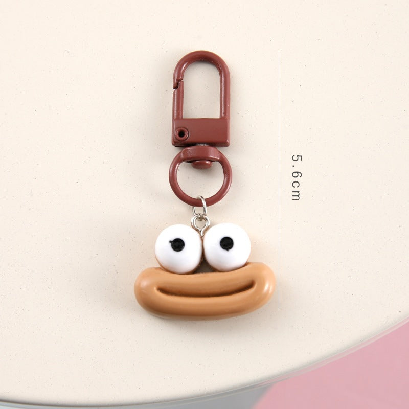 Close-up of a blue cartoon face keychain, showcasing its detailed, charming expression.