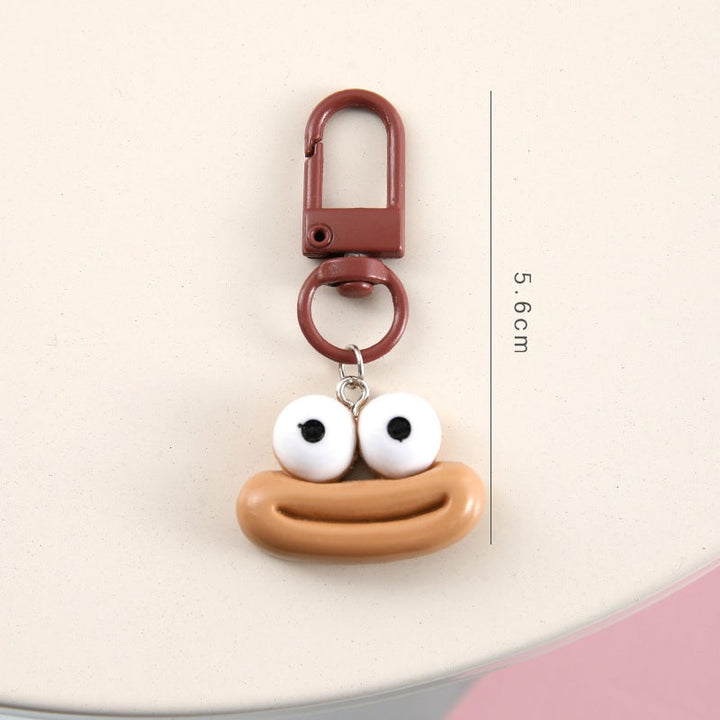 Close-up of a blue cartoon face keychain, showcasing its detailed, charming expression.