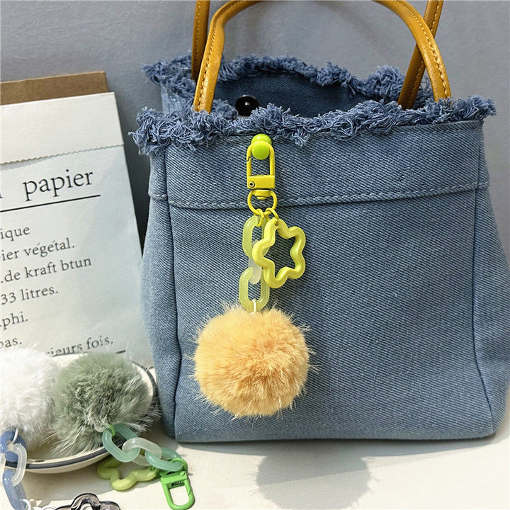 Women's cute fuzzy pom-pom bag charm. Soft and playful keychain accessory.
