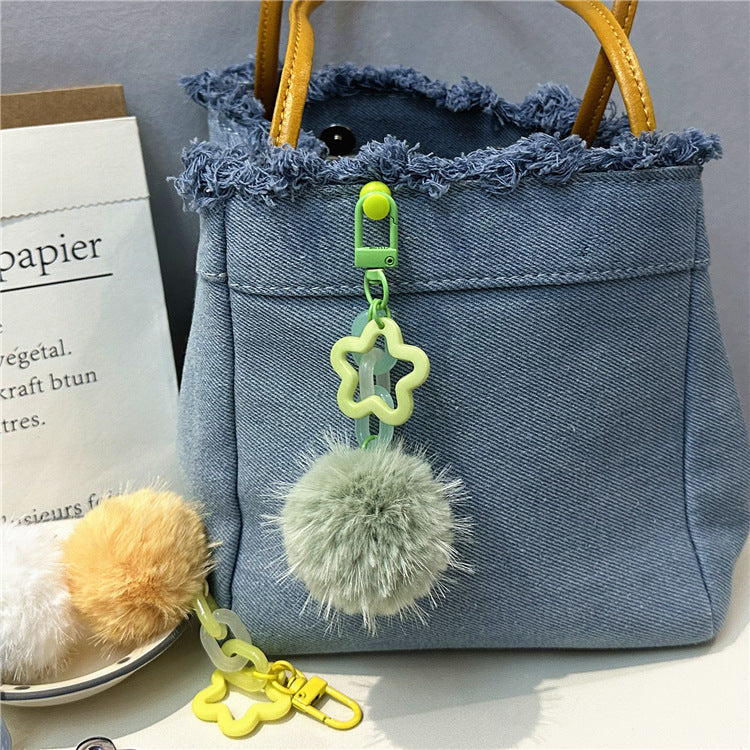 Soft fuzzy pom-pom keychain, a vibrant bag accessory for women. Cute & playful.