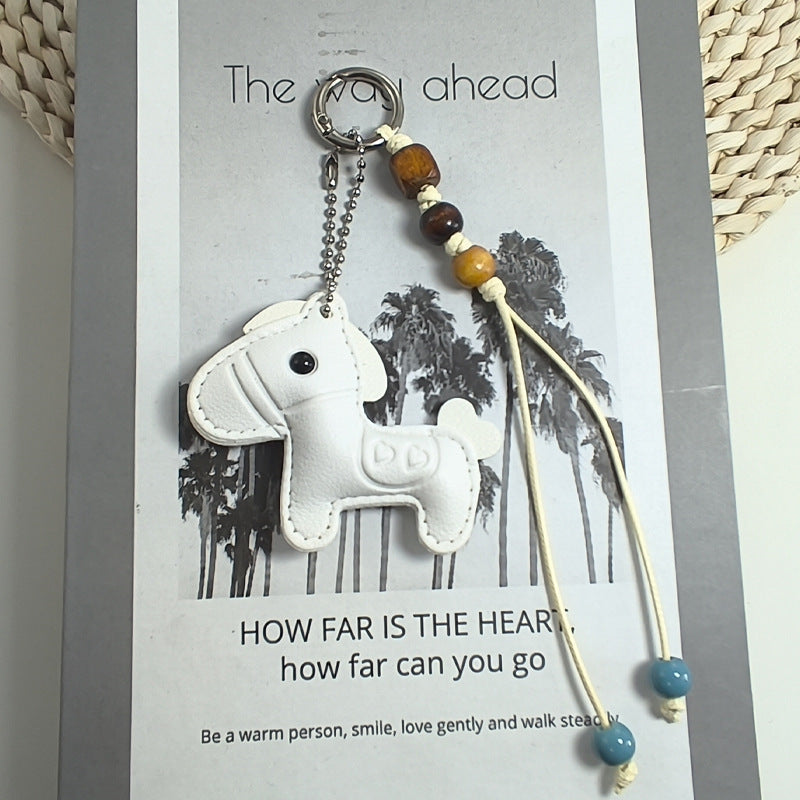 Cute off-white bear keychain crafted from synthetic leather, perfect as a charming bag accessory or key holder.