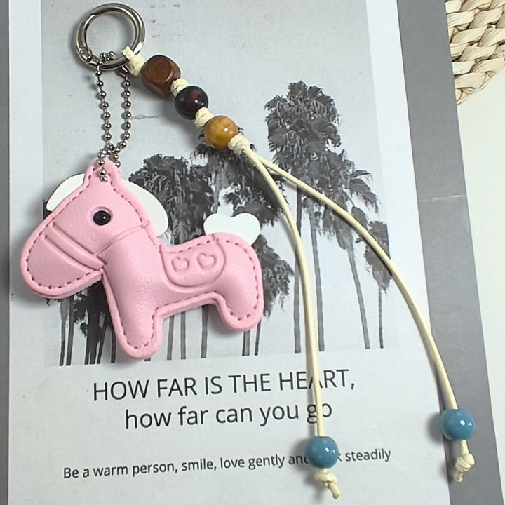 Adorable pink rabbit keychain made of durable synthetic leather, ideal for keys or as a stylish bag charm.
