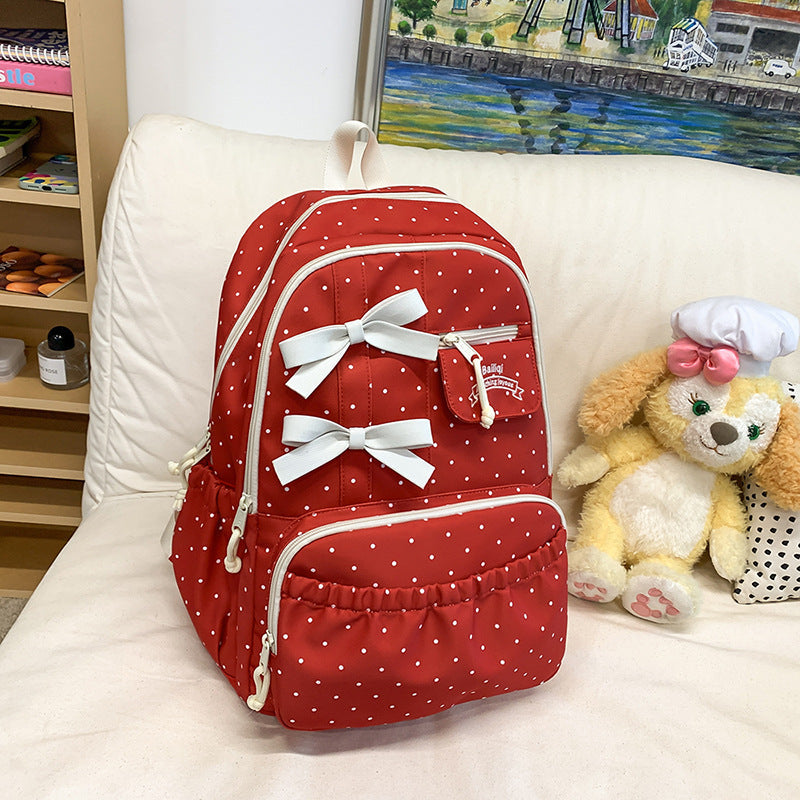 Fashionable girls' polka dot bow school backpack, a cute & lightweight student bag for daily use.