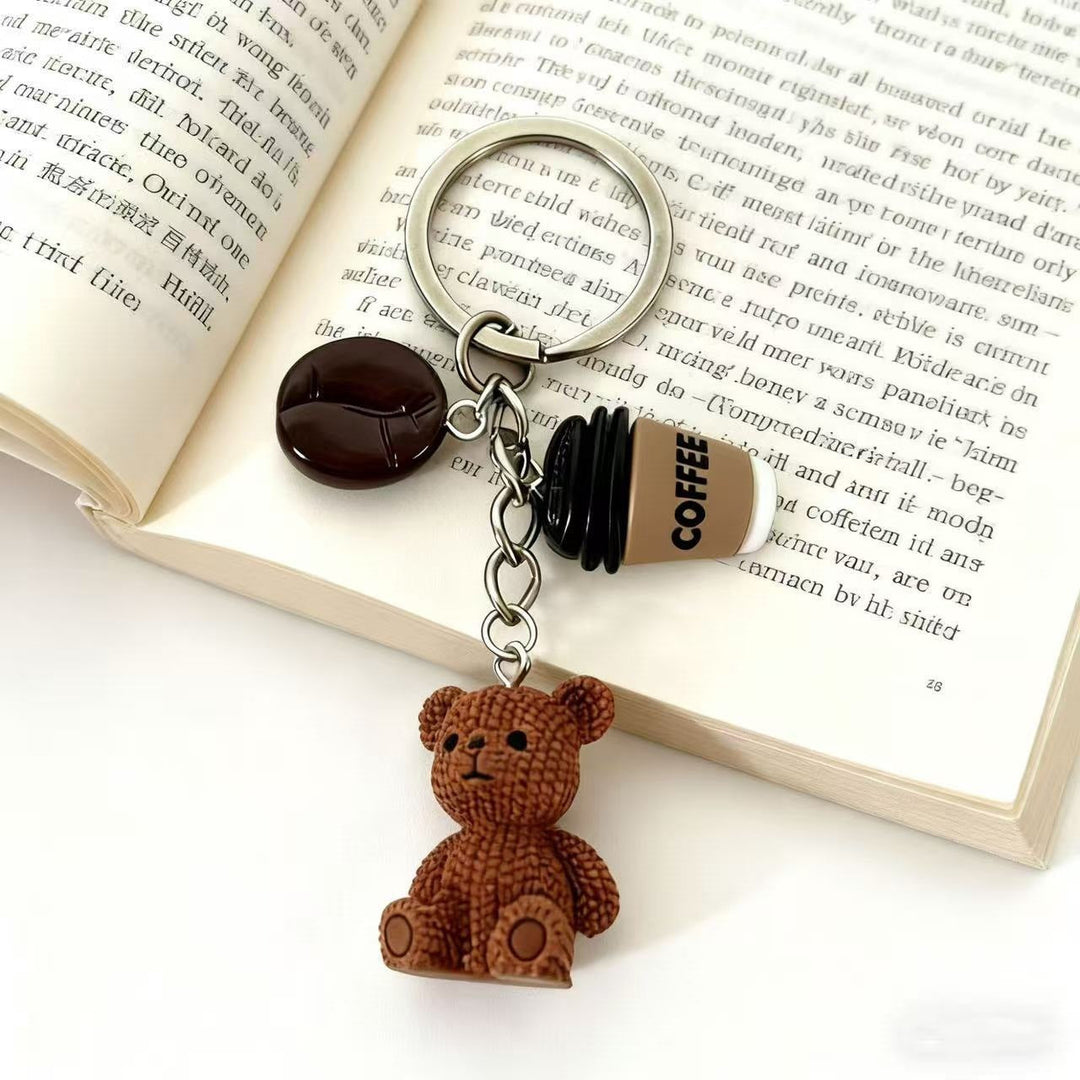 Cute playful bear and drink keychain charm. Perfect bag accessory or gift idea for animal lovers.